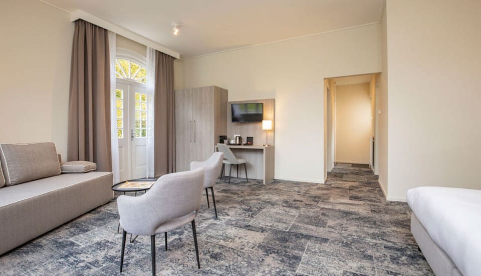 Spread out with lounge seating and a handy work desk.