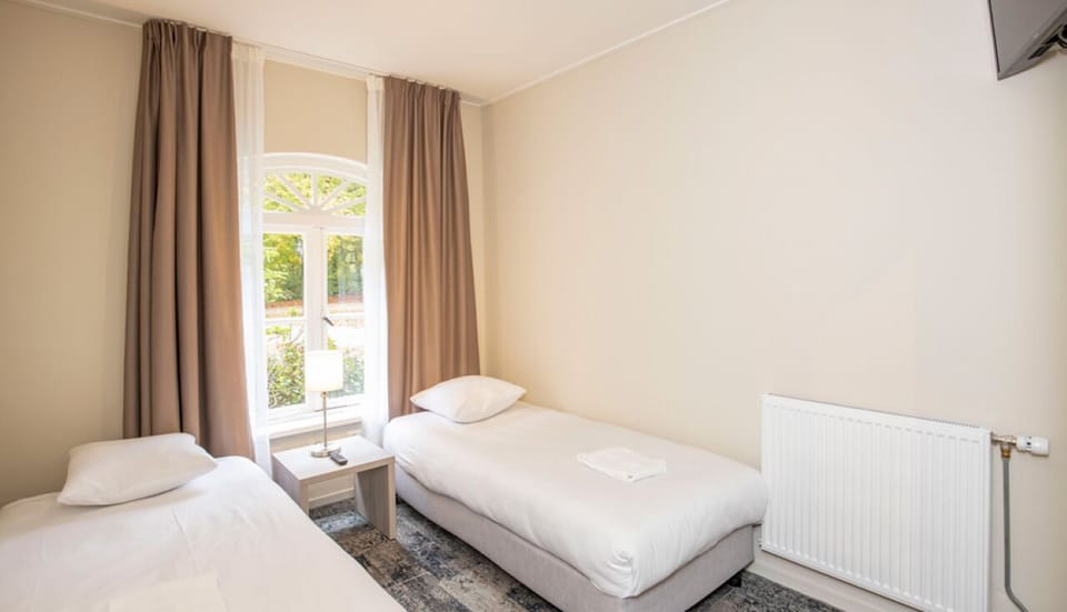 Settle into crisp twin beds for a quiet, restorative sleep.