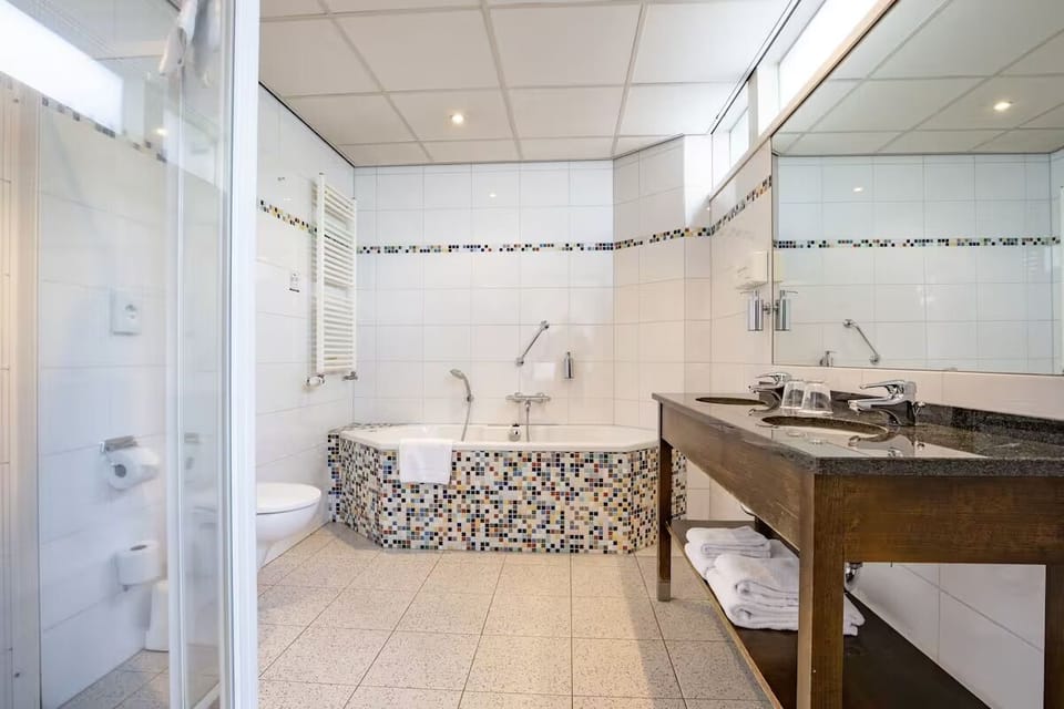 Refresh in a bright bathroom with tub and generous counter.
