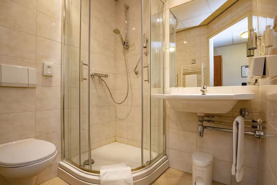 Rinse off in a clean, modern glass shower enclosure.