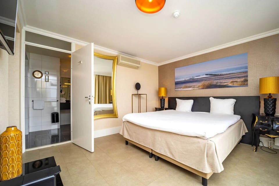 Unwind in a cozy king bed with warm lighting.