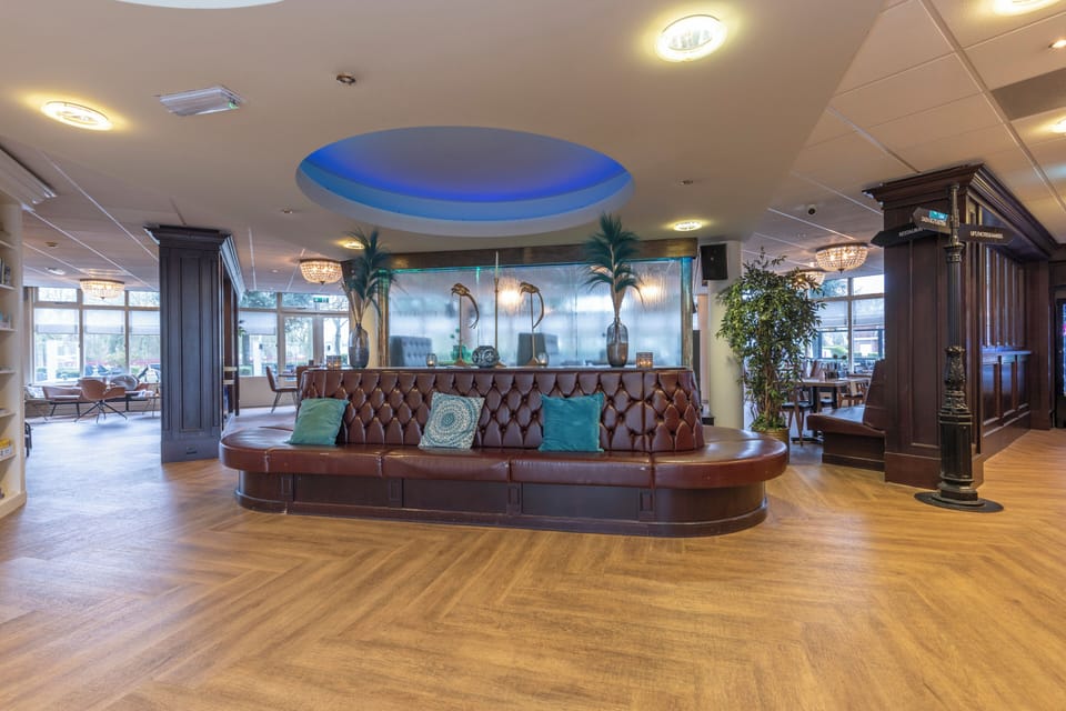 Unwind on the statement leather banquette under soft chandelier glow.