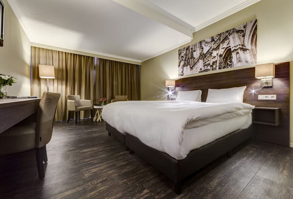 Unwind in a plush king bed with warm evening glow.