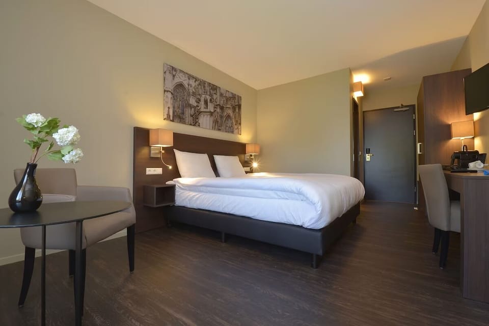 Relax with a cozy seating corner beside your restful bed.