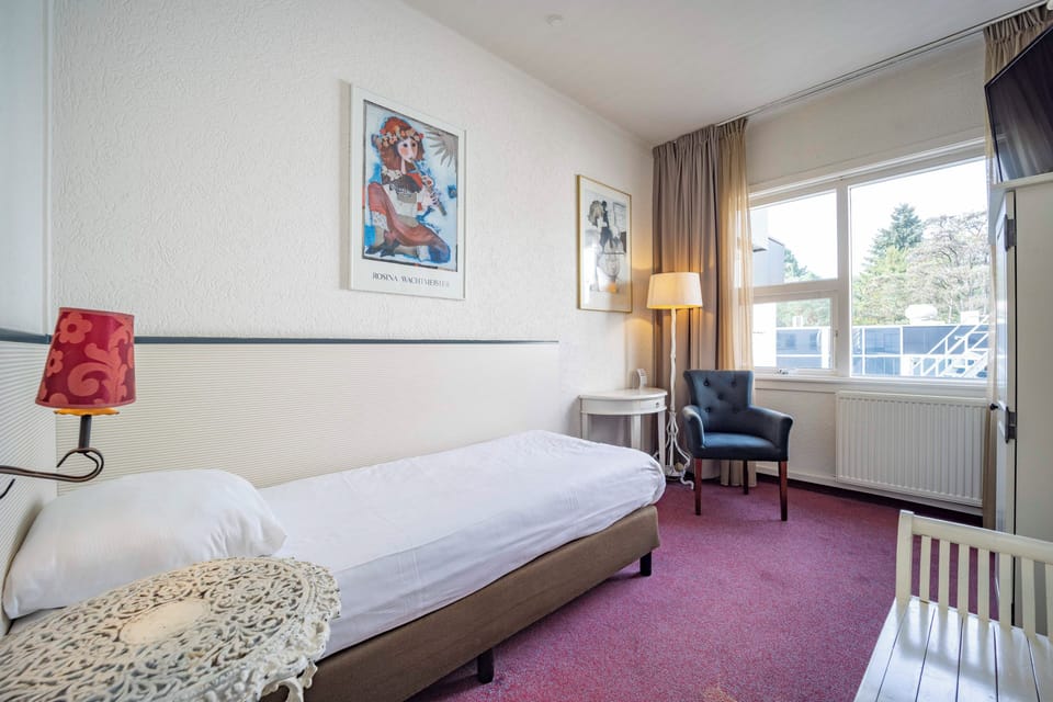 Unwind in a bright single room with peaceful window views.