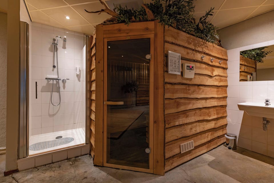 Recharge in the warm sauna, then rinse off in luxury.