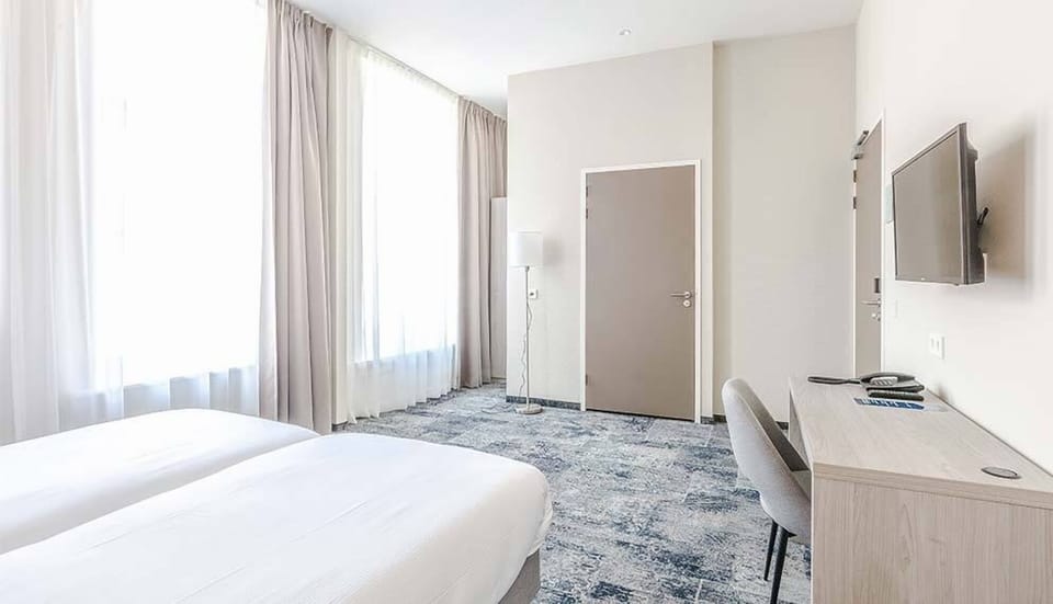 Wake to soft daylight streaming through tall, airy curtains.