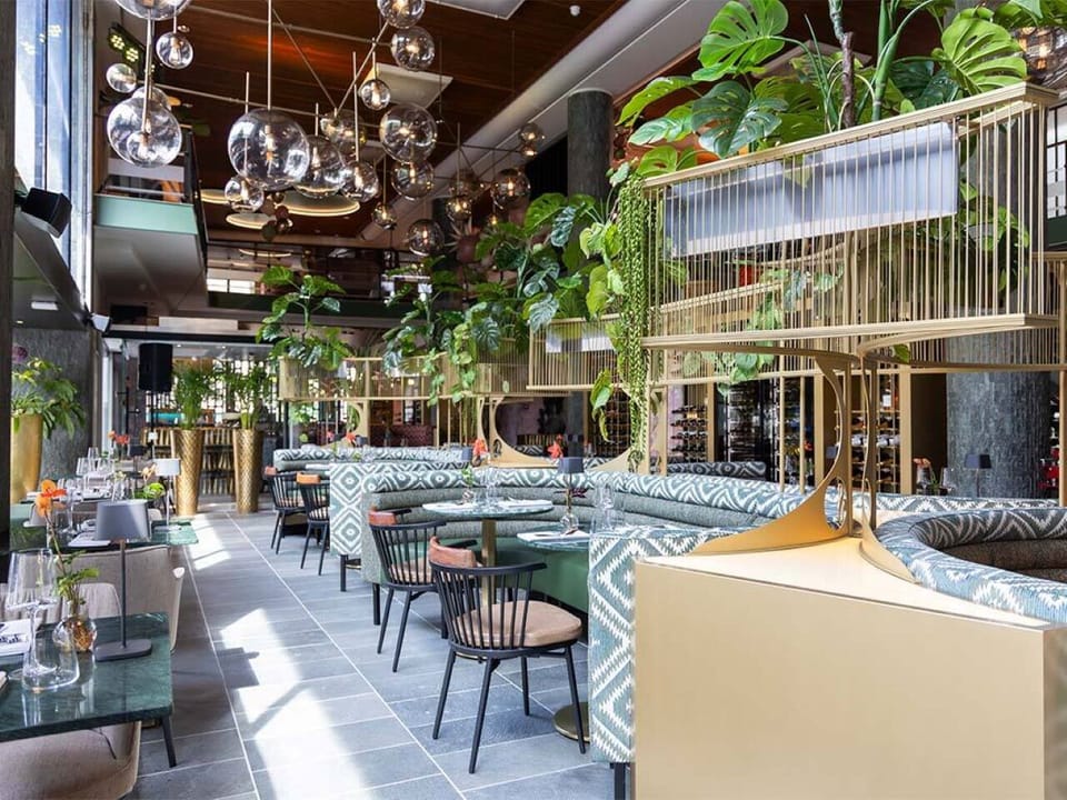 Step into a vibrant dining hall filled with botanical elegance.