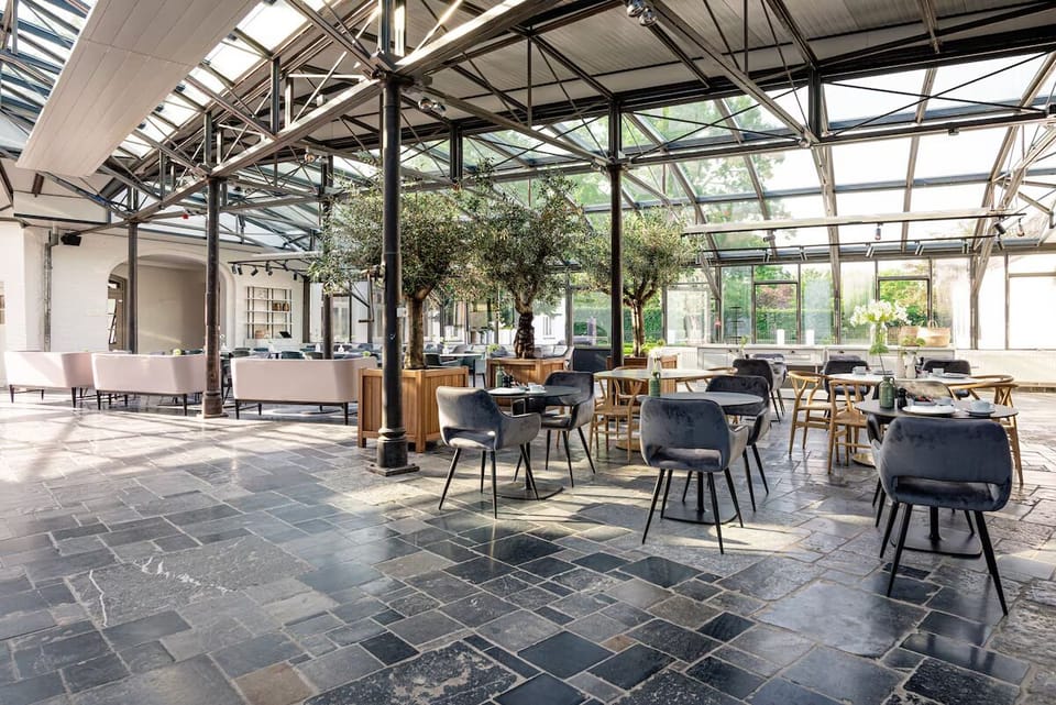 Step into a sunlit atrium restaurant with airy elegance.