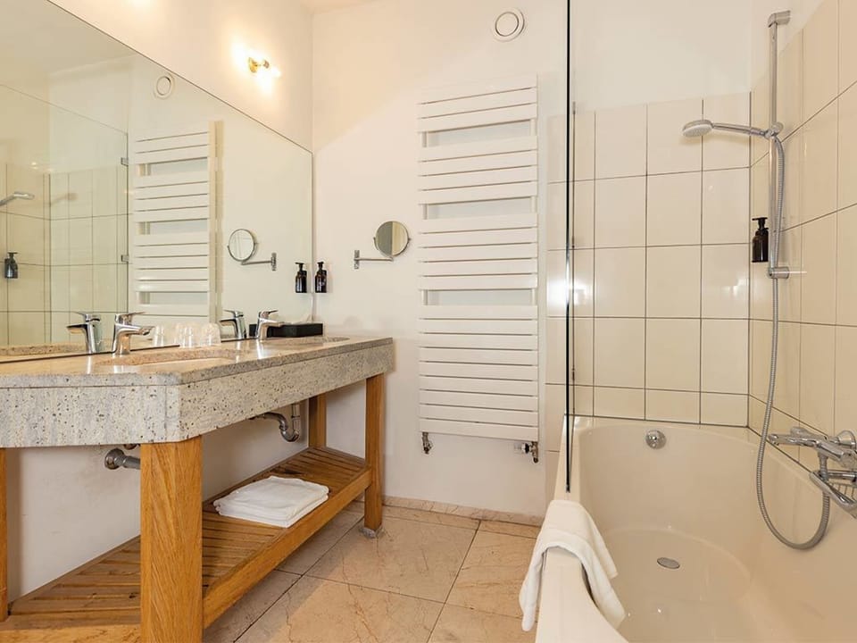 Refresh in a bright bath with tub and rain shower.