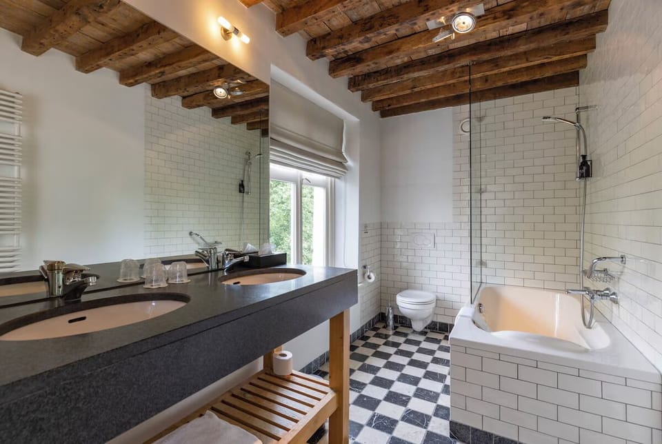 Indulge in a spa-like bathroom with tub and rainfall shower.