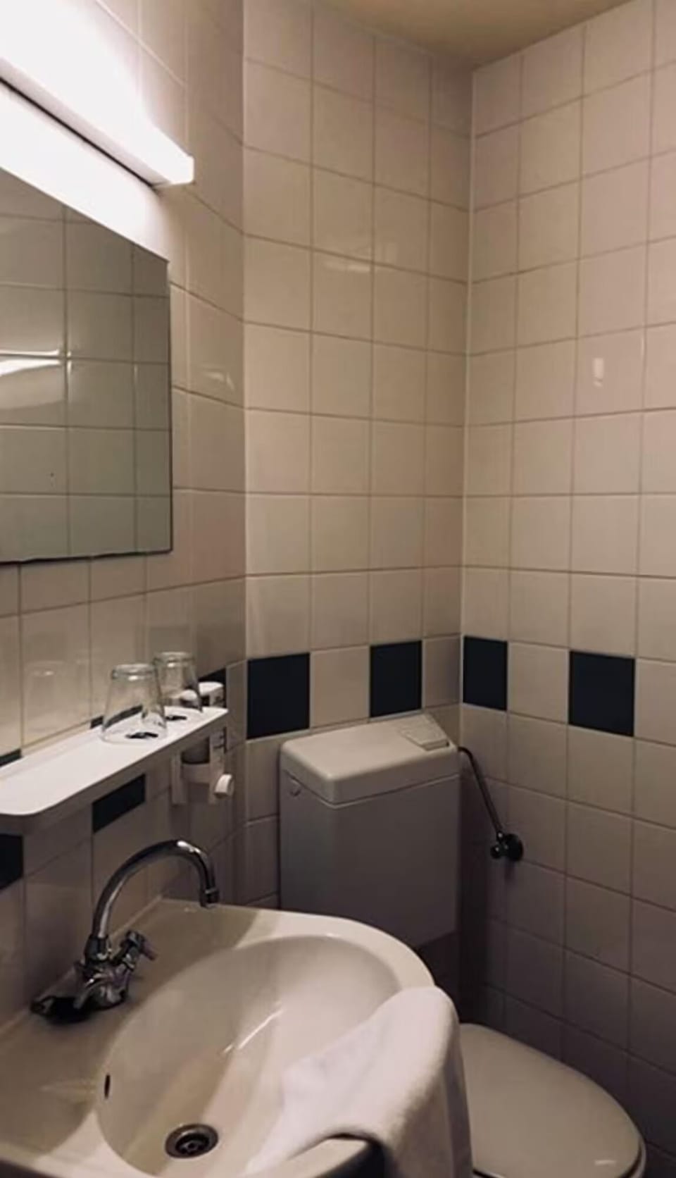 Refresh easily in a clean, practical bathroom with bright mirror.