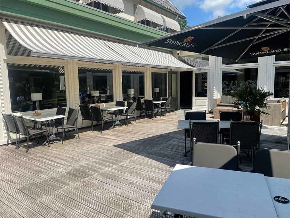 Linger outdoors with shaded tables and laid-back terrace vibes.