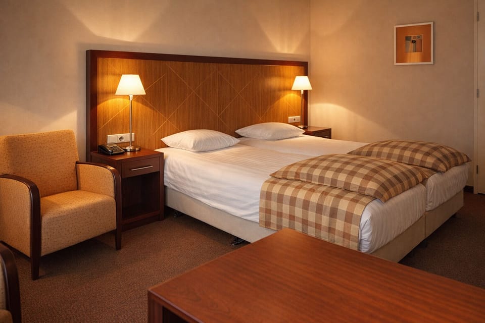Stretch out and recharge in a calm, softly lit bedroom.