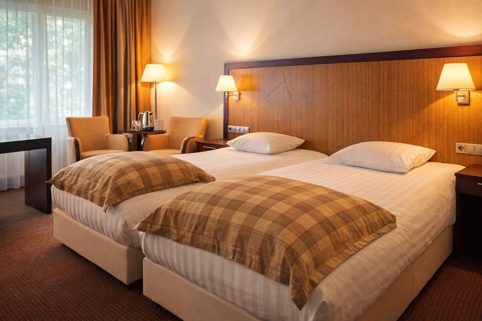 Wake up gently to soft daylight beside cozy lounge chairs.