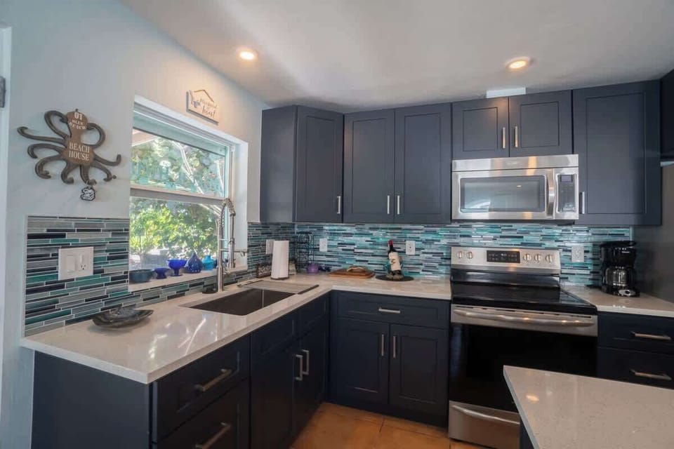 Open kitchen with newer appliances, offering a bright and functional space perfect for cooking and gathering.