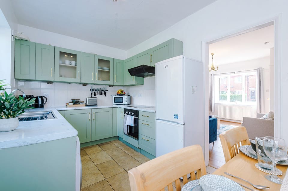 Open-plan kitchen and dining area - the table currently seats four