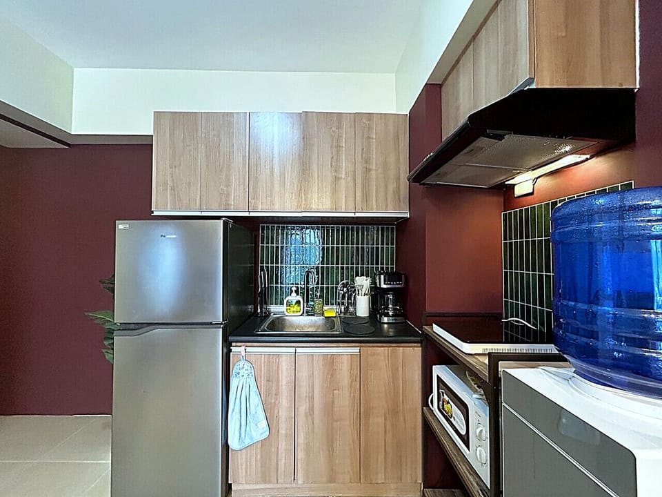 Modern kitchen setup featuring spacious storage, complete cooking essentials, and purified water station.