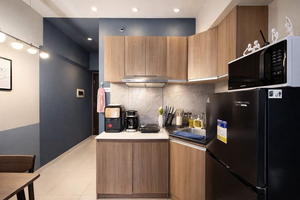 Functional kitchenette setup featuring stove, sink, appliances, and long-stay friendly amenities.