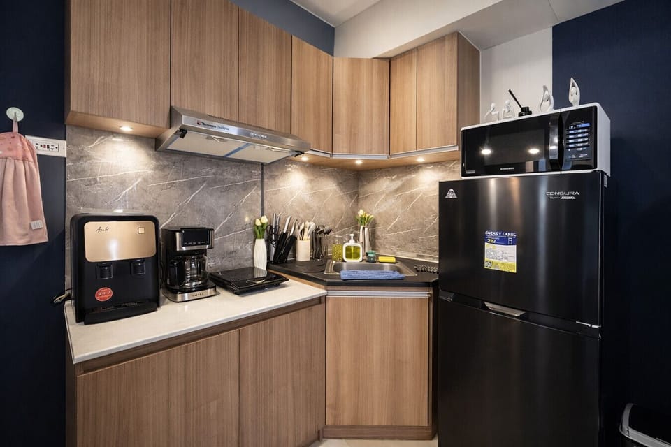 Complete kitchenette with fridge, microwave, coffee maker, cooktop, and all cooking essentials provided.