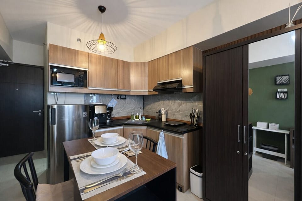 Cook, dine, and feel at home—spacious kitchen setup with dining table and all the appliances you need
