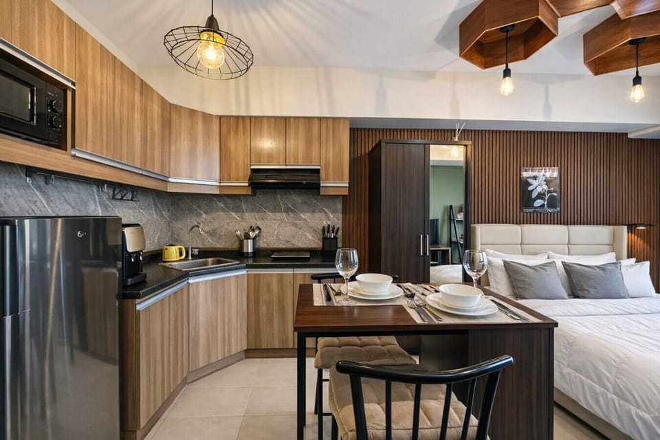 Bright and functional layout with full kitchenette, cozy bed, and stylish dining space in one seamless design.