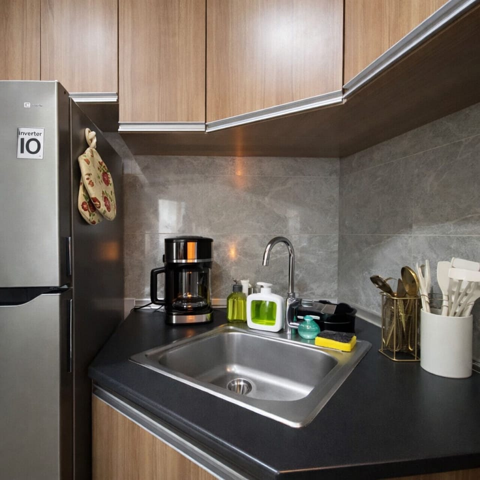 Fully equipped kitchenette with coffee maker, sink, cooking utensils, and dishwashing essentials for easy meals.