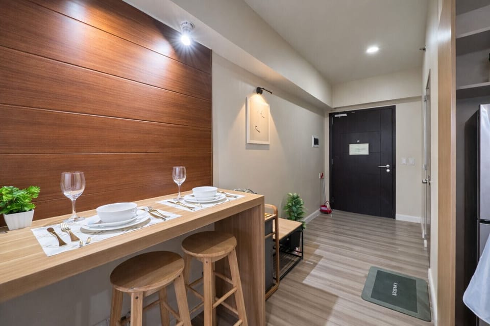 Cozy dining bar for two with a clean modern entryway—perfect for meals, coffee, or a quick workspace setup