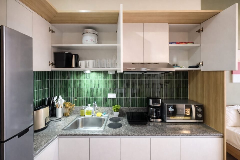 Cook with ease in this bright studio kitchenette featuring full-size fridge, appliances, and everything you need to dine in.