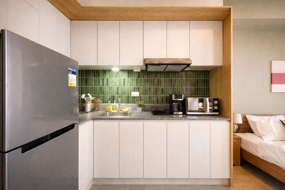 Cook with ease in this bright studio kitchenette featuring full-size fridge, appliances, and everything you need to dine in.