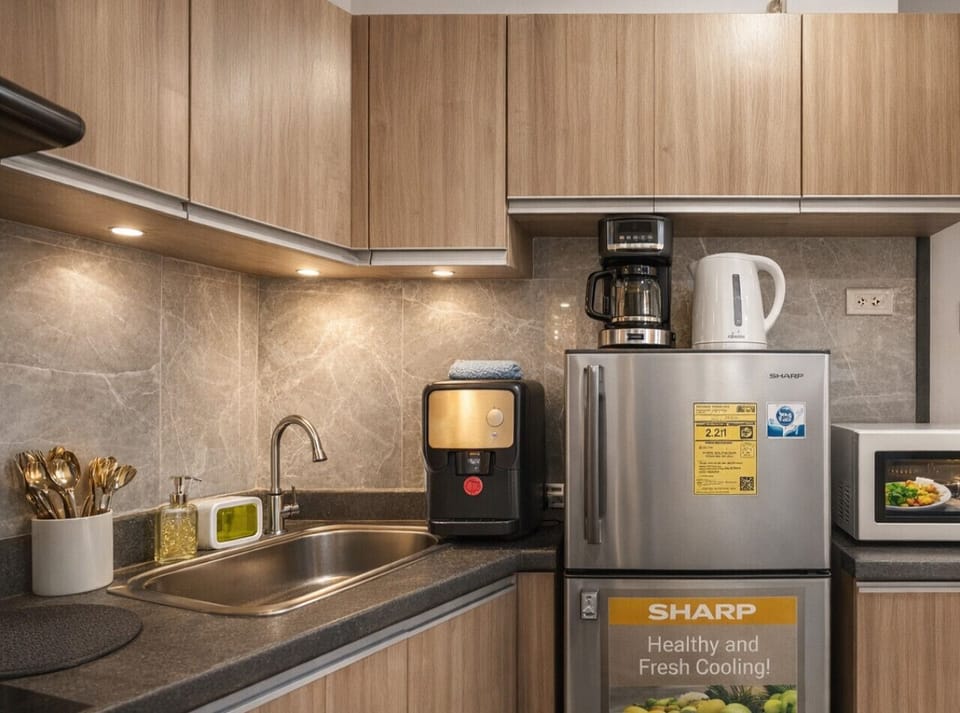 Fully equipped kitchenette with coffee maker, electric kettle, microwave, fridge, and sink—perfect for short or long stays.