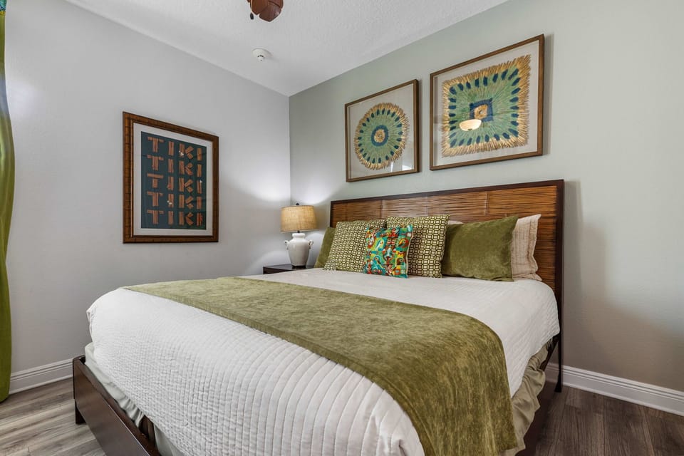 Island-inspired king bedroom with relaxing tropical vibes and wall-mounted smart TV.