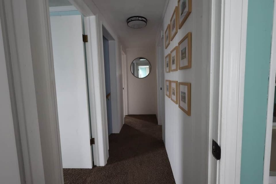 The hallway between the bedrooms includes vintage postcards from Conneaut.