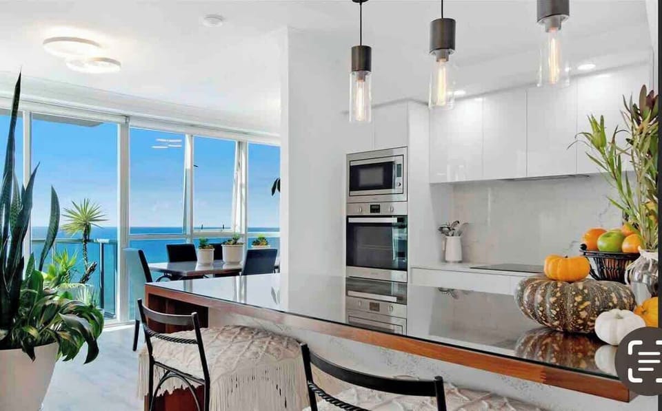 Kitchen ️:
Culinary indulgence awaits in our gourmet kitchen, equipped with top-of-the-line appliances. Prepare feasts on gleaming marble countertops while savoring panoramic views of the city skyline and ocean  