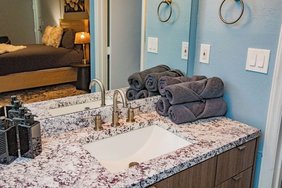 Bathroom sink area with fresh towels