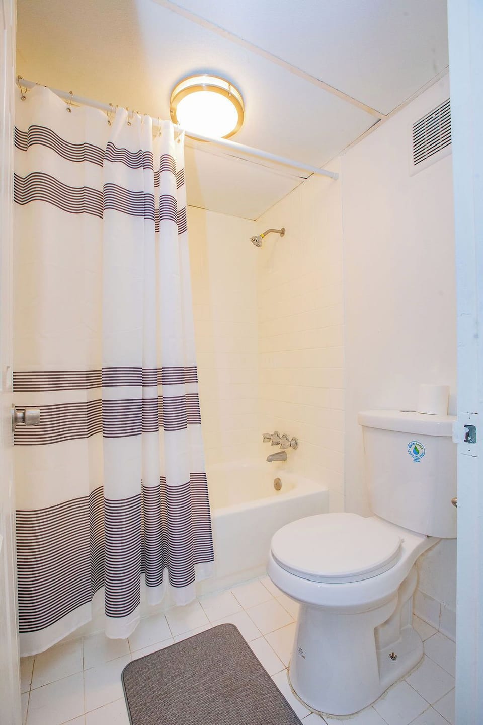 Bathroom with Bath Tub with Shower Head and a toilet