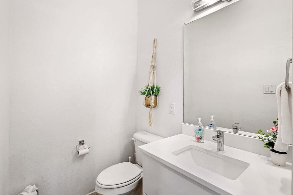 Bright and clean half bathroom with modern fixtures and minimalist decor.