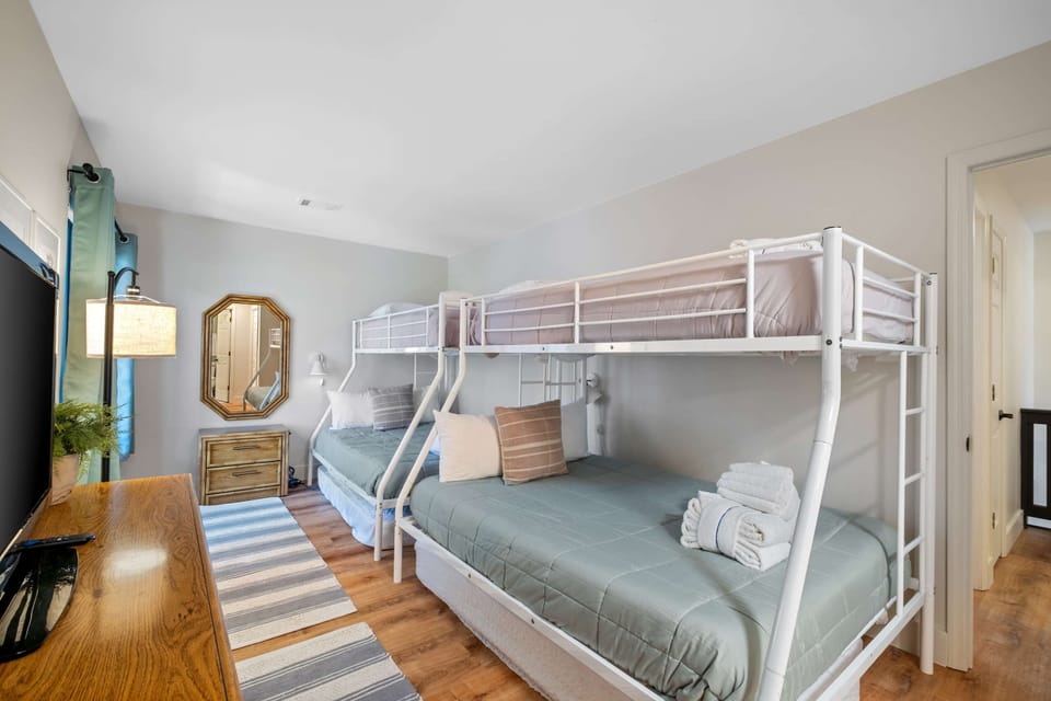 Bunk room with two twin-over-full bunk beds, views overlooking the first deck.