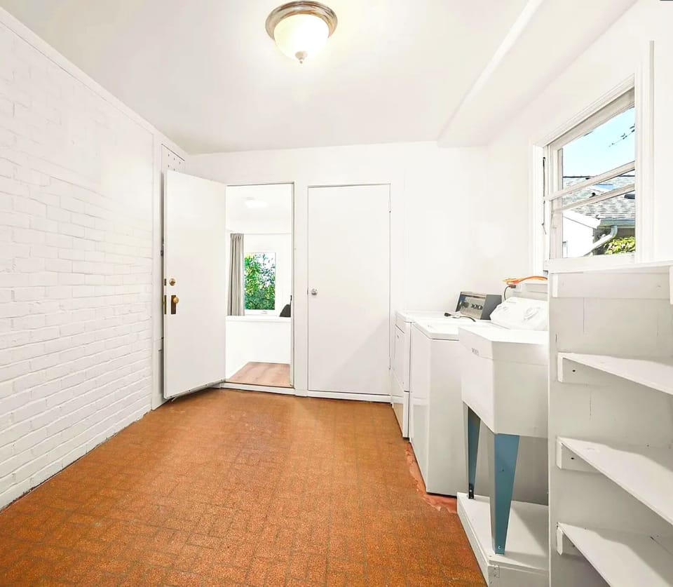 Private laundry room exclusively for studio guest use, equipped with washer, dryer, and utility sink for added convenience.