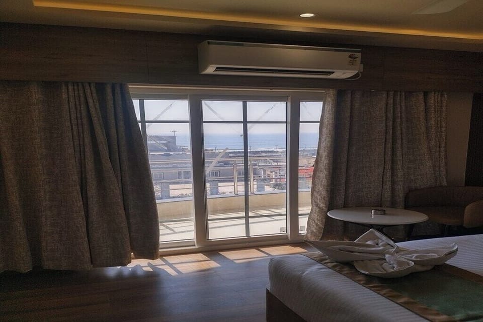 Deluxe Room, 1 King Bed, Balcony, Sea View | Laptop workspace, WiFi (free), bed sheets