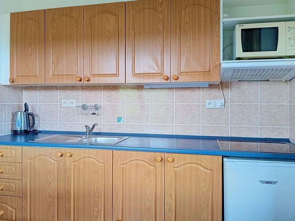 Wood, Cabinetry, Flooring, Kitchen, Countertop, Kitchen Sink, Interior Design, Floor, Plumbing Fixture, Major Appliance
