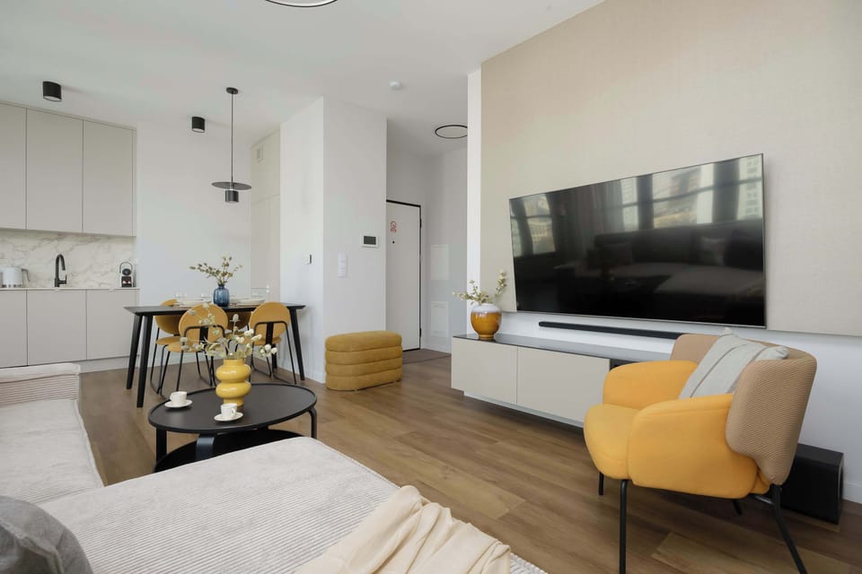 The elegant living room featuring a double sofa bed, perfect for relaxing or sleeping.