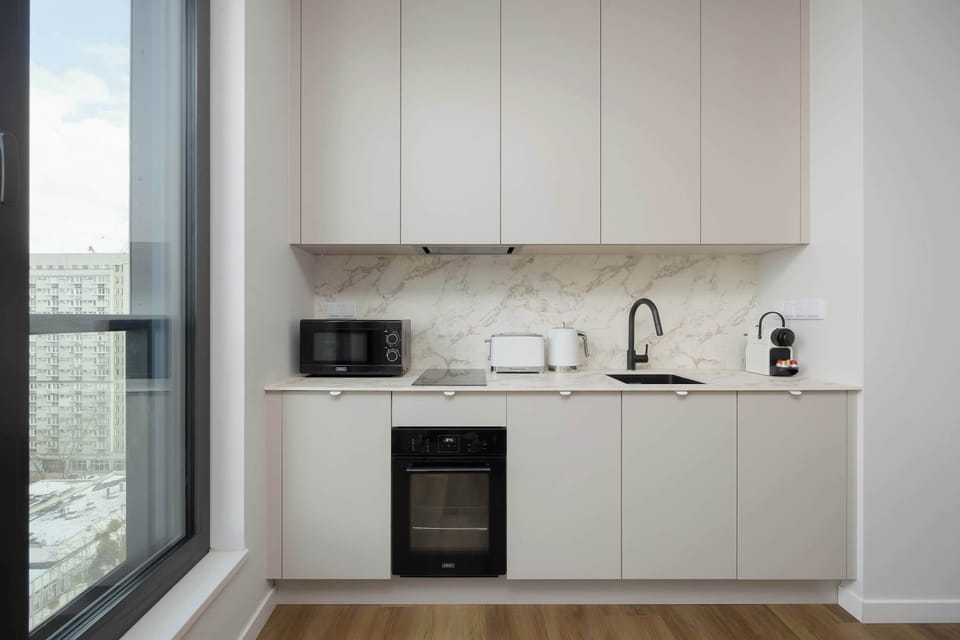 The sleek design of the kitchenette blending seamlessly with the living area.