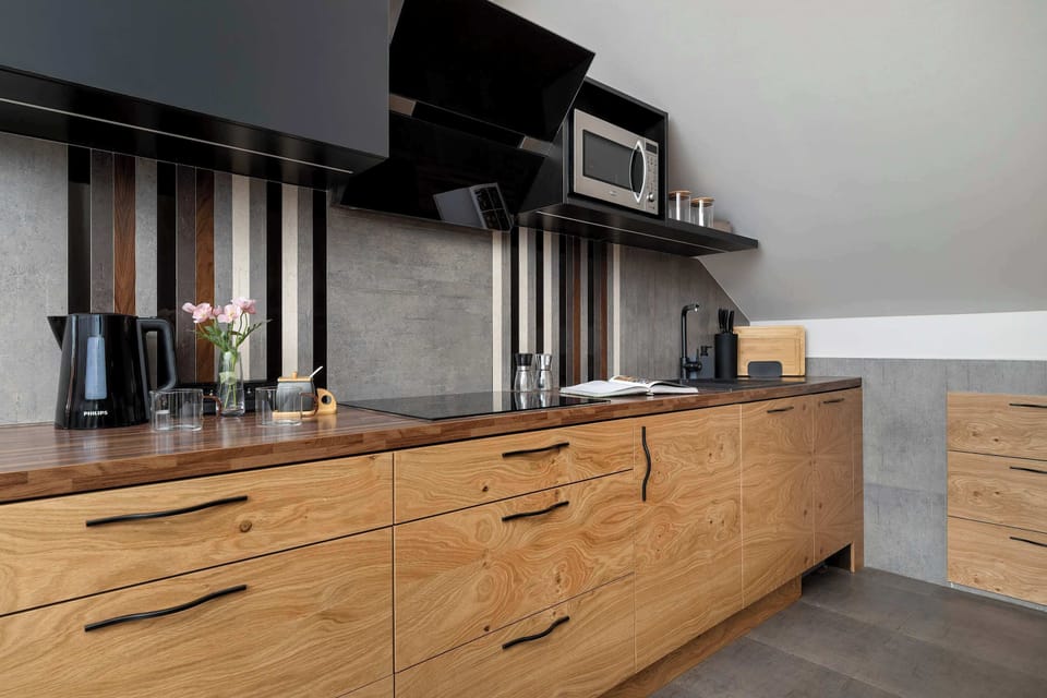 A close-up of the kitchen cabinets and countertop, showing detailed wood finishes. The sleek design blends functionality and style.