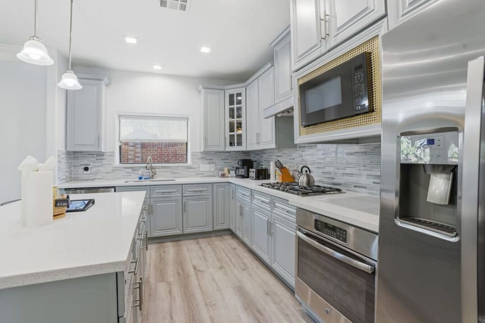 Fully equipped kitchen featuring stainless appliances, generous counter space, custom cabinetry, and modern finishes—perfect for home-cooked meals, quick breakfasts, or hosting shared dinners.