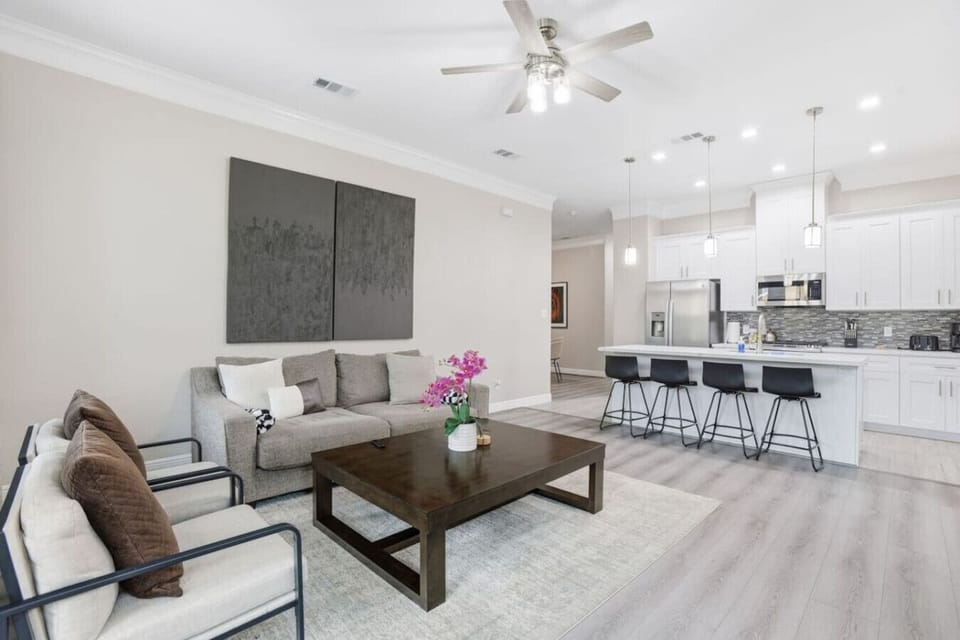 Bright open-concept gathering area where the living space flows seamlessly into the kitchen, perfect for relaxing or sharing meals together.