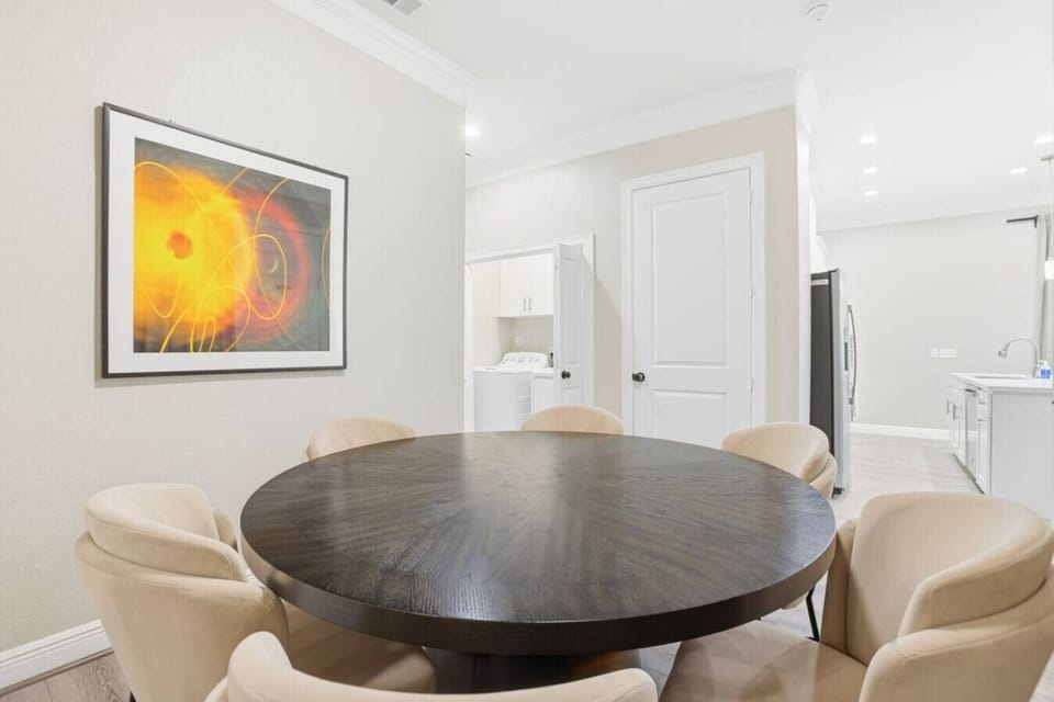 A closer look at the dining setup, highlighting the round table and six chairs—perfect for gathering, meals, or casual meetings.