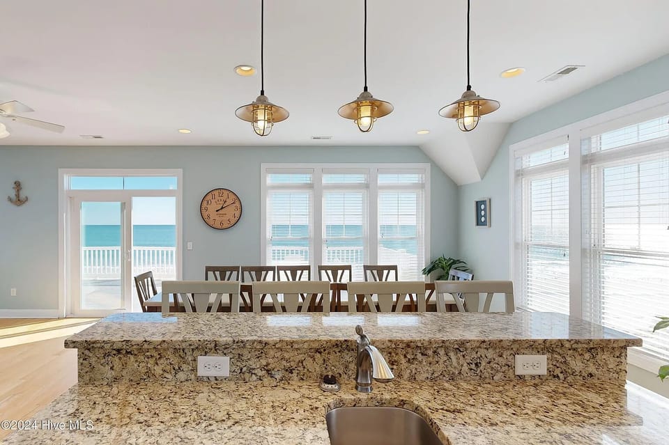 Stylish pendant lighting over the granite breakfast bar