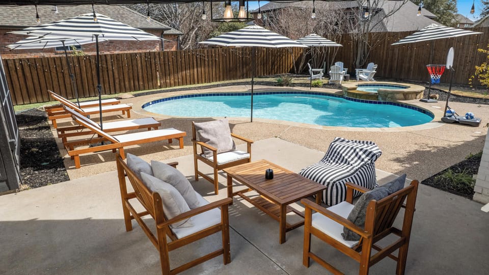 Relax in your private backyard oasis featuring a sparkling pool, and comfortable lounge seating—perfect for soaking up the Texas sun or unwinding with your group.