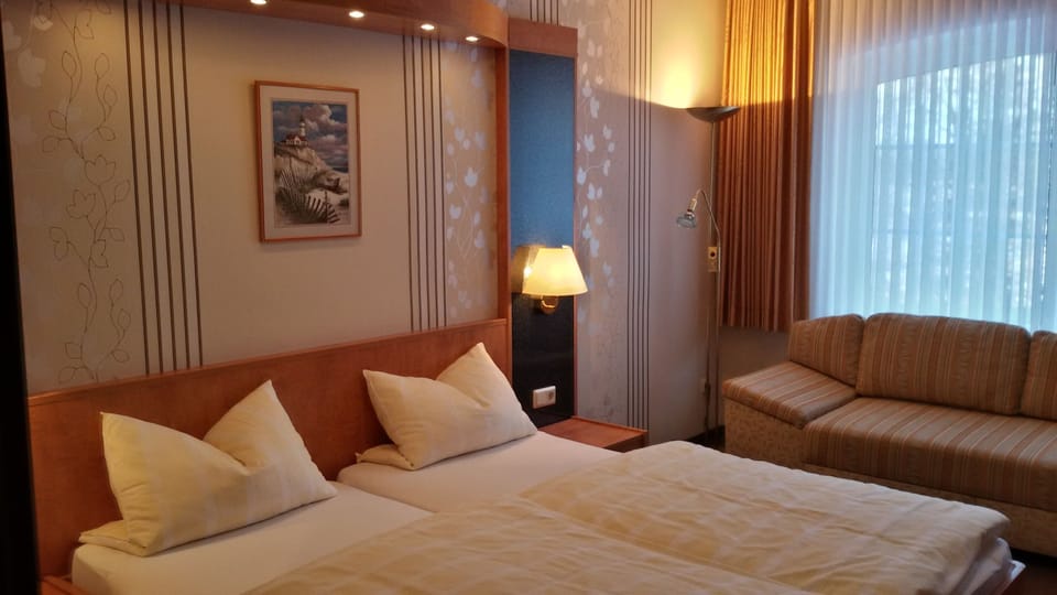 Premium bedding, desk, laptop workspace, blackout drapes